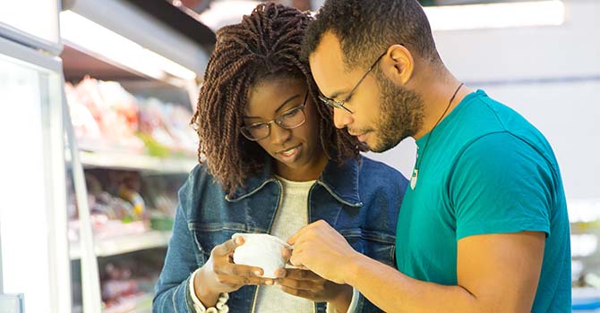 Couple reading ingredients on a frozen package.